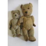 Two vintage teddies, both with amber eyes, orange plush and fabric pads, one with a sewn nose,