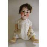 A Heubach Koppelsdorf bisque socket head doll, with brown glass sleeping eyes, open mouth, short