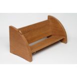 A ROBERT THOMPSON ADZED OAK BOOK TROUGH of oblong form, the quadrant ends with bracket feet,