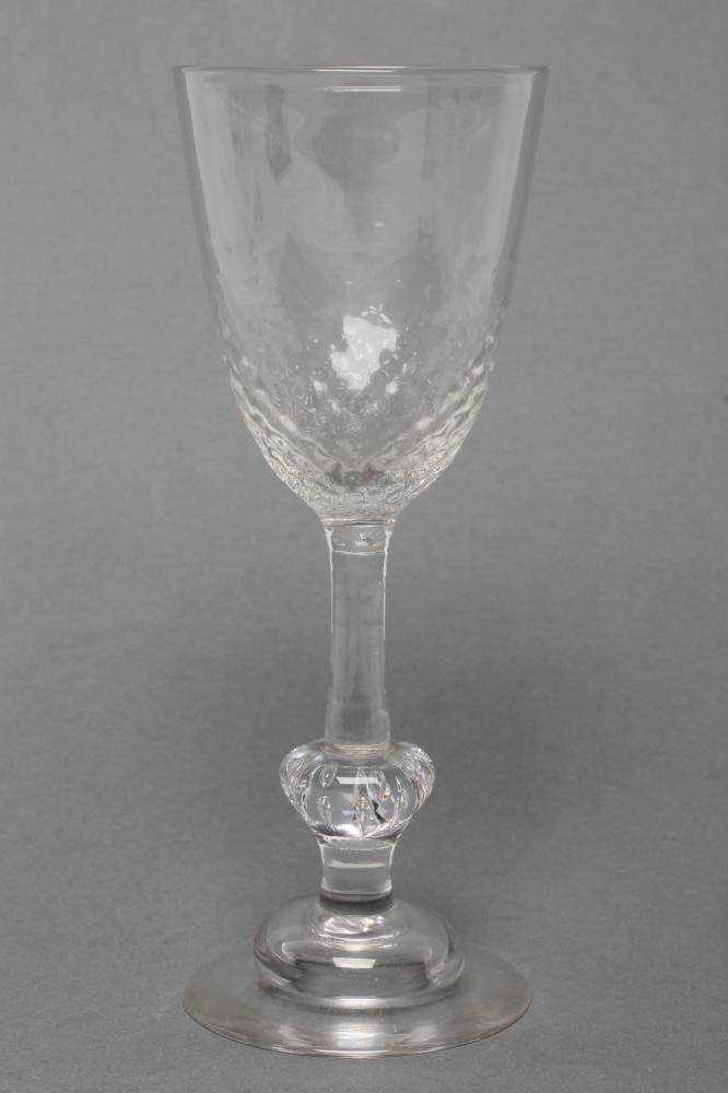 A WINE GLASS, mid 18th century, the honeycomb mould blown round funnel bowl on plain stem, with