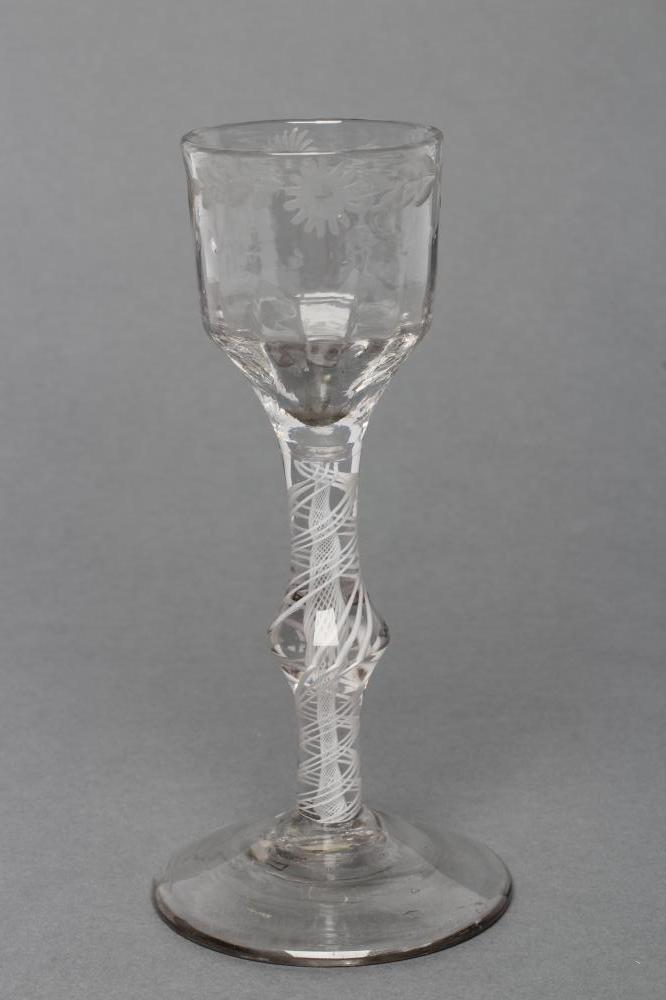 A CORDIAL GLASS, mid 18th century, the vertical mould blown ogee bowl with wheel engraved flowerhead