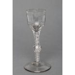 A CORDIAL GLASS, mid 18th century, the vertical mould blown ogee bowl with wheel engraved flowerhead