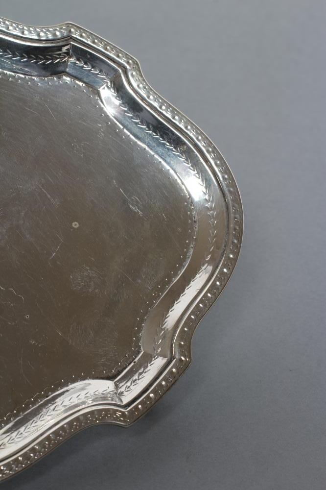 A GEORGE III TEAPOT STAND, maker's mark BM (Jackson states un-traced), London 1783, of lobed oval - Image 3 of 4