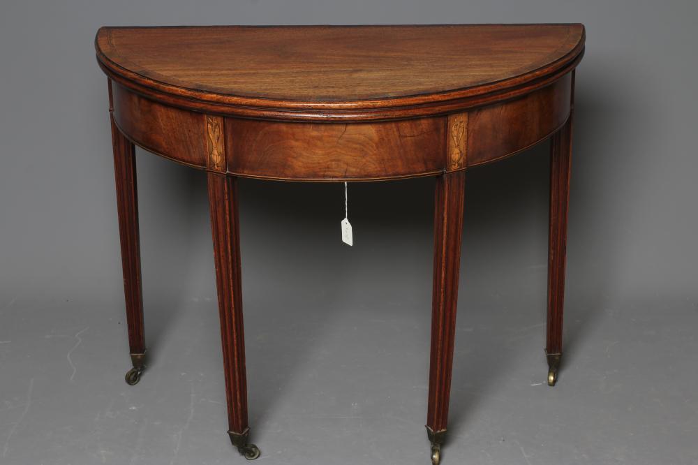 A GEORGIAN MAHOGANY FOLDING TEA TABLE, late 18th century, of demi lune form, the moulded edged and