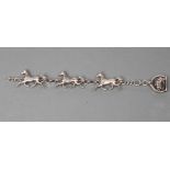 A HEAVY SILVER TRIPLE HORSE BRACELET, the three dimensional cast carriage horses with plain circular