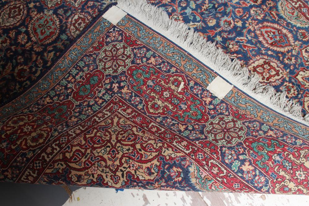 A PERSIAN RUG, the navy blue floral field centred by an ivory circular gul with matching - Image 4 of 4