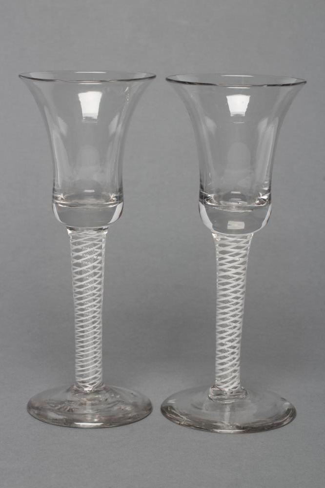 A PAIR OF WINE GLASSES, late 18th century, the bell bowls on mixed twist stems with two central