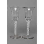 A PAIR OF WINE GLASSES, late 18th century, the bell bowls on mixed twist stems with two central