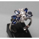 A SAPPHIRE AND DIAMOND DRESS RING, the two marquise set sapphire "flowers" interspersed with a