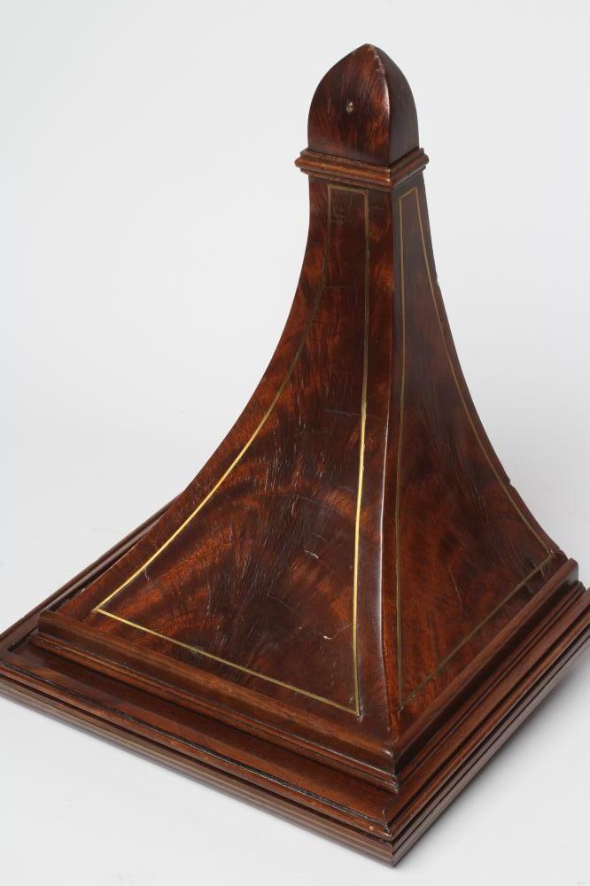 A REGENCY MAHOGANY CLOCK WALL BRACKET, the moulded edged oblong top on tapering support with brass