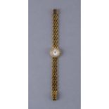 A LADY'S LONGINES 18CT GOLD AND DIAMOND WRISTWATCH, the white dial with gilt batons, the quartz five