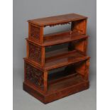 A SMALL VICTORIAN WALNUT FREE STANDING OPEN BOOKCASE of stepped rounded oblong form, the four