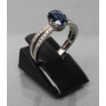 A CEYLON SAPPHIRE AND DIAMOND DRESS RING, the oval facet cut sapphire of 1.06cts, claw set to open