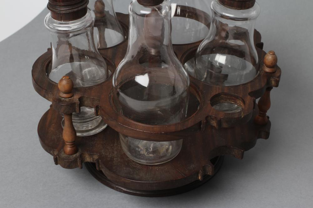 A GEORGIAN HARDWOOD FIVE BOTTLE CRUET AND STAND, late 18th century, the original clear glass - Image 4 of 5