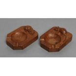 A PAIR OF ROBERT THOMPSON ADZED OAK ASHTRAYS of canted oblong form, each with carved mouse trademark