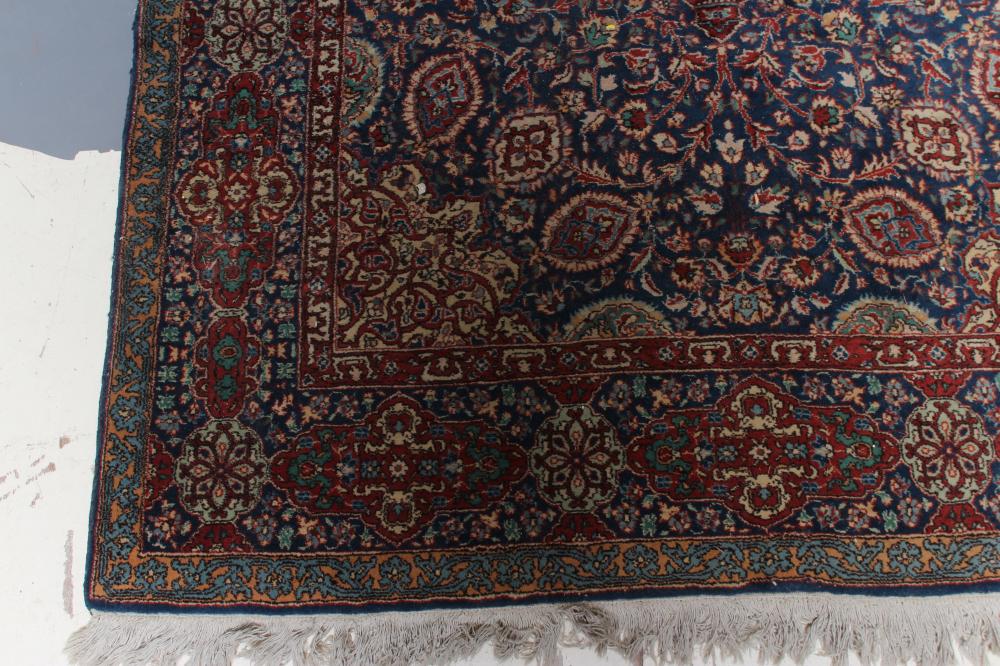 A PERSIAN RUG, the navy blue floral field centred by an ivory circular gul with matching - Image 2 of 4
