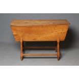 AN ELM DOUGH BIN, 19th century, of oblong tapering form with detachable lid, raised on baluster
