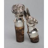 A PAIR OF CONTINENTAL CORK BOTTLE STOPPERS hollow stamped as a hare and beagle head, stamped 900,