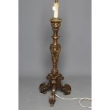 AN ITALIAN CARVED AND GILTWOOD STANDARD LAMP, 20th century, modelled as a Baroque alter candle