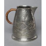 ARCHIBALD KNOX FOR LIBERTY - a Tudric pewter jug of tapering rounded cylindrical form, repousse with