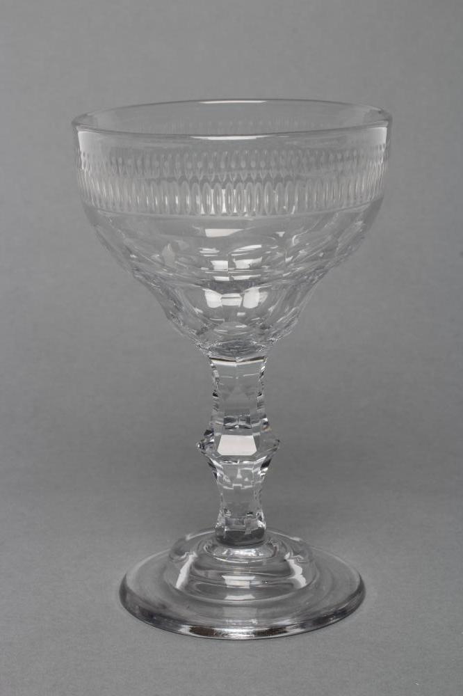 A SWEETMEAT GLASS, late 18th century, the panel cut wide ogee bowl on central knopped faceted stem