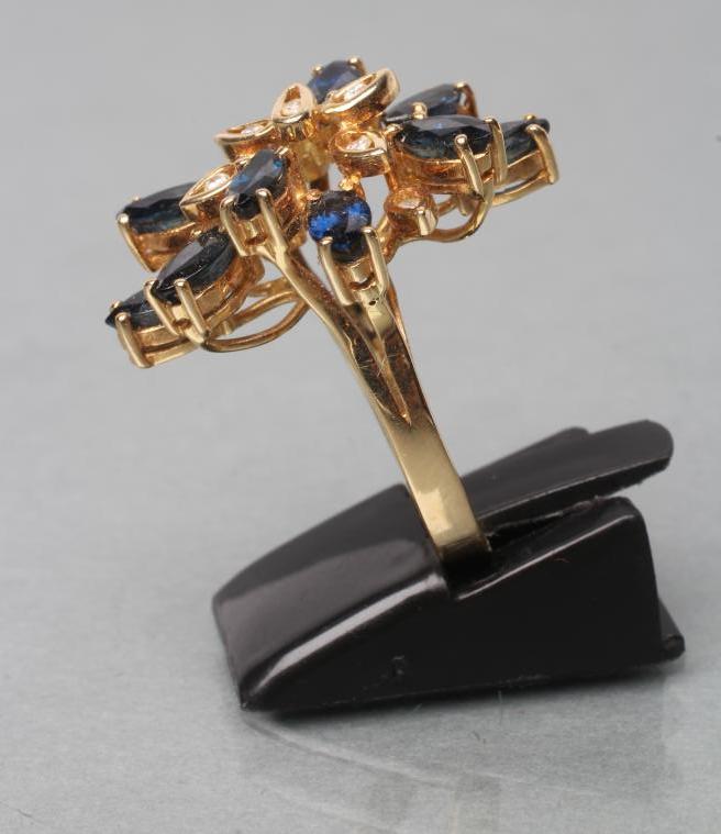 A SAPPHIRE AND DIAMOND COCKTAIL RING, set with ten marquise cut sapphires and nine single channel - Image 3 of 3