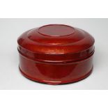 A LARGE VIETNAMESE RED LACQUER BETEL BOX AND COVER, modern, of plain cylindrical form with lift-