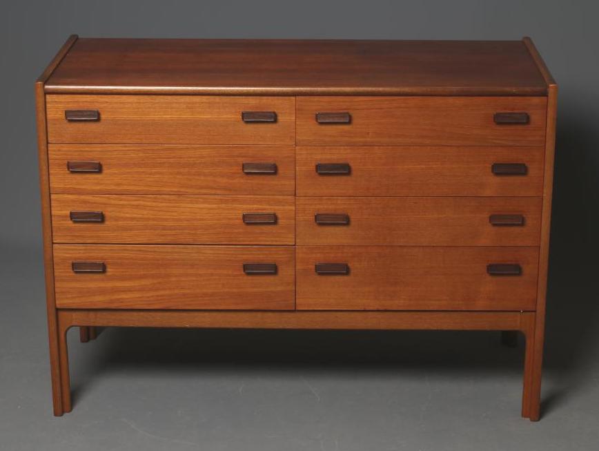 A TEAK CABINET, mid 20th century, comprising two banks each of four graduated drawers with formosa