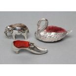 THREE NOVELTY SILVER PIN CUSHIONS comprising a shoe with bow and buckle on a Louis heel,