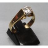 A SOLITAIRE DIAMOND RING, the brilliant cut stone of approximately 0.6cts claw set to a wide