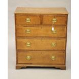 AN OAK AND MAHOGANY BANDED CHEST, early 19th century, the moulded edged top over two short and three