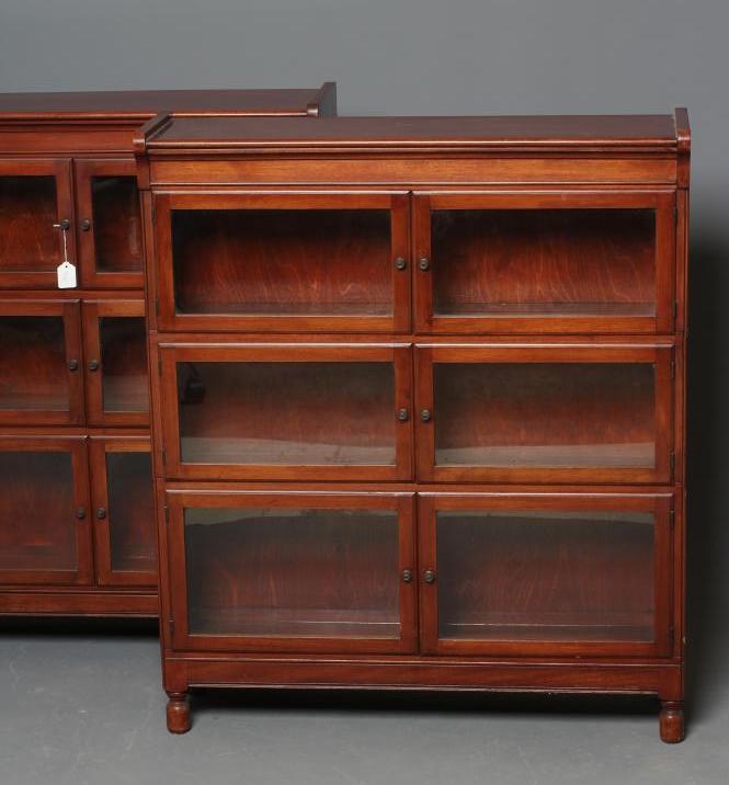 A PAIR OF MAHOGANY BOOKCASES, early 20th century, each with six glazed folding doors enclosing three