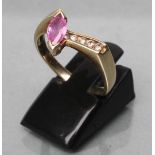 A PINK SAPPHIRE AND DIAMOND ANGULAR CROSSOVER RING, the marquise cut sapphire beside four