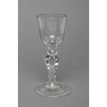 A CORDIAL GLASS, mid 18th century, the ogee bowl on a knopped square section tapering stem and