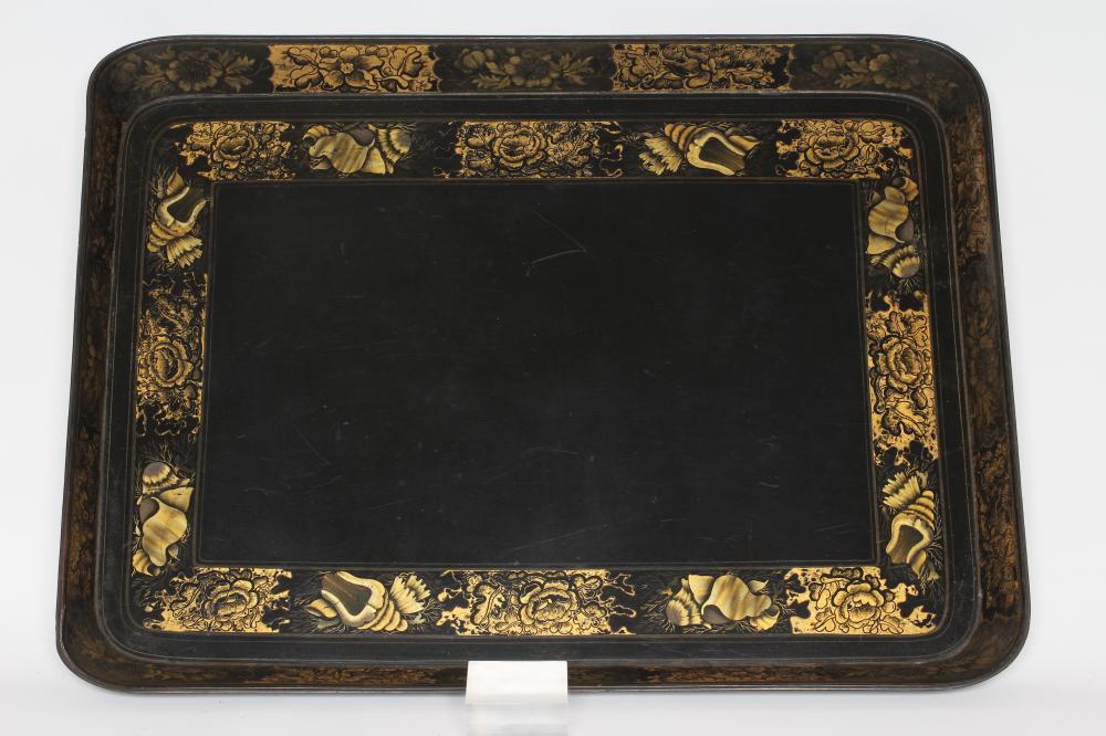 A LARGE PAPIER MACHE TEA TRAY, early 19th century, of rounded oblong form painted and gilded with