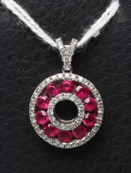 A RUBY AND DIAMOND "DOUGHNUT" PENDANT, the channel set round facet cut rubies to borders of small