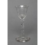 A WINE GLASS, late 18th century, the round funnel bowl with pendant husk and foliate engraved rim,