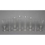 A COLLECTION OF EIGHT CHAMPAGNE FLUTES, early 19th century and later, six with panelled bowls, on