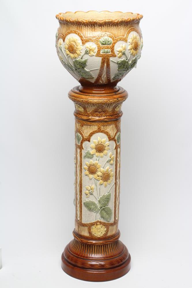 A BURMANTOFTS FAIENCE JARDINIERE AND STAND, early 20th century, moulded in relief and painted in