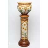 A BURMANTOFTS FAIENCE JARDINIERE AND STAND, early 20th century, moulded in relief and painted in