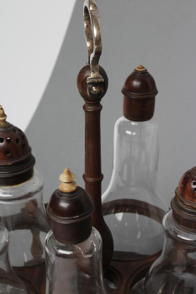 A GEORGIAN HARDWOOD FIVE BOTTLE CRUET AND STAND, late 18th century, the original clear glass - Image 3 of 5