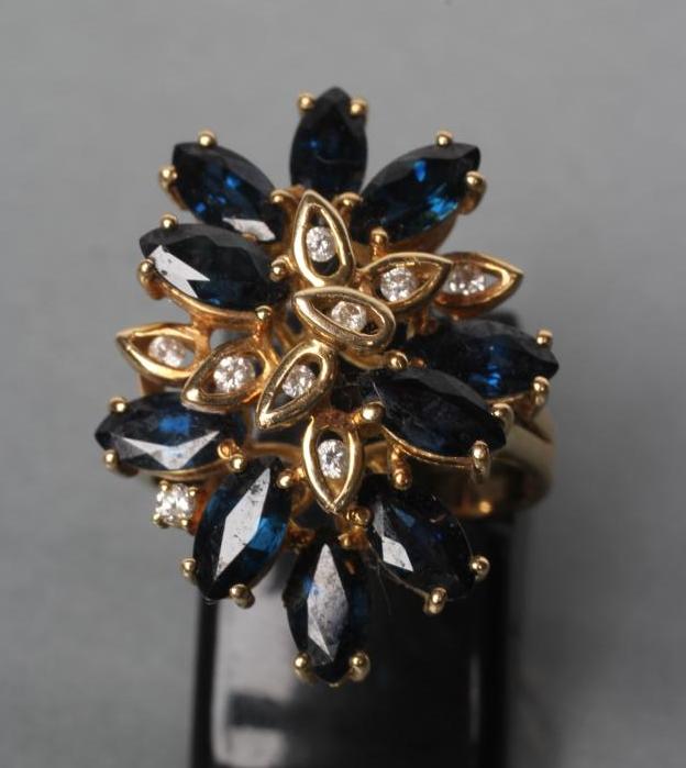 A SAPPHIRE AND DIAMOND COCKTAIL RING, set with ten marquise cut sapphires and nine single channel - Image 2 of 3