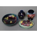 A COLLECTION OF MOORCROFT CLEMATIS PATTERN POTTERY, mid 20th century, all tubelined and painted in