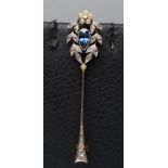 A SAPPHIRE AND DIAMOND ARROW BROOCH, the facet tear cut sapphire open back collet set to a rose