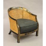 A BLACK LACQUERED CHINOISERIE TUB CHAIR, early 20th century, the double caned back with arched top