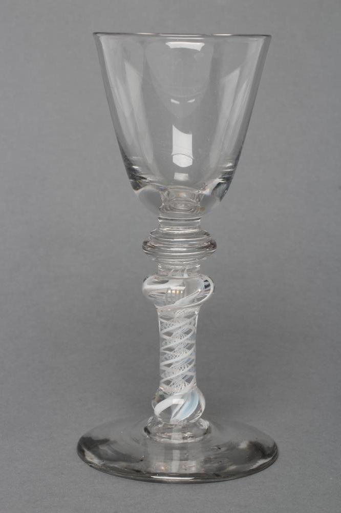 A COMPOSITE WINE GLASS, mid 18th century, the round funnel bowl on annulated knop over a further