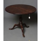 A GEORGIAN MAHOGANY TRIPOD TABLE, third quarter of the 18th century, the circular tip-up top on