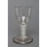 A FIRING GLASS, mid 18th century, the plain ogee bowl on an opaque twist stem with central gauze