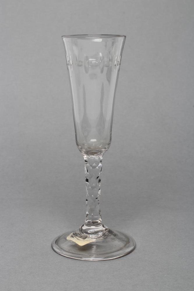 AN ALE FLUTE, late 18th century, the funnel bowl with slice cutting, on a facet cut stem and