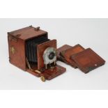 A W. WATSON & SONS PLATE CAMERA with leather bellows, Goerz lens, the mahogany case with brass